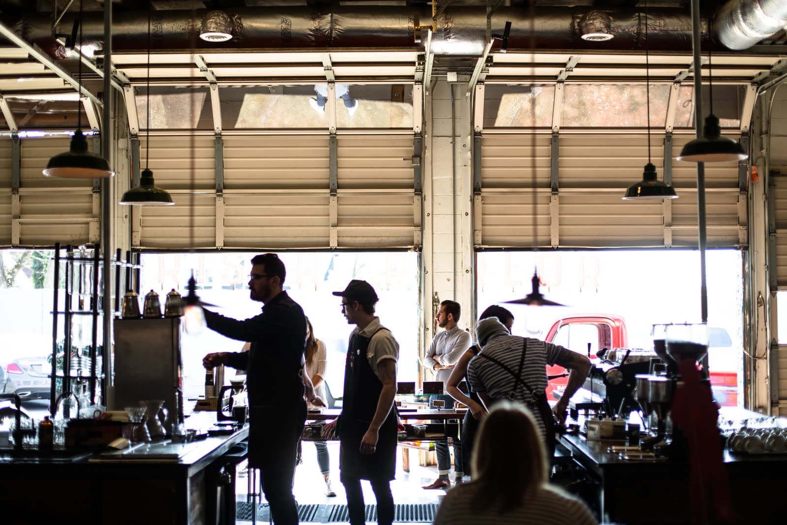 Staff working behind the counter of a busy café